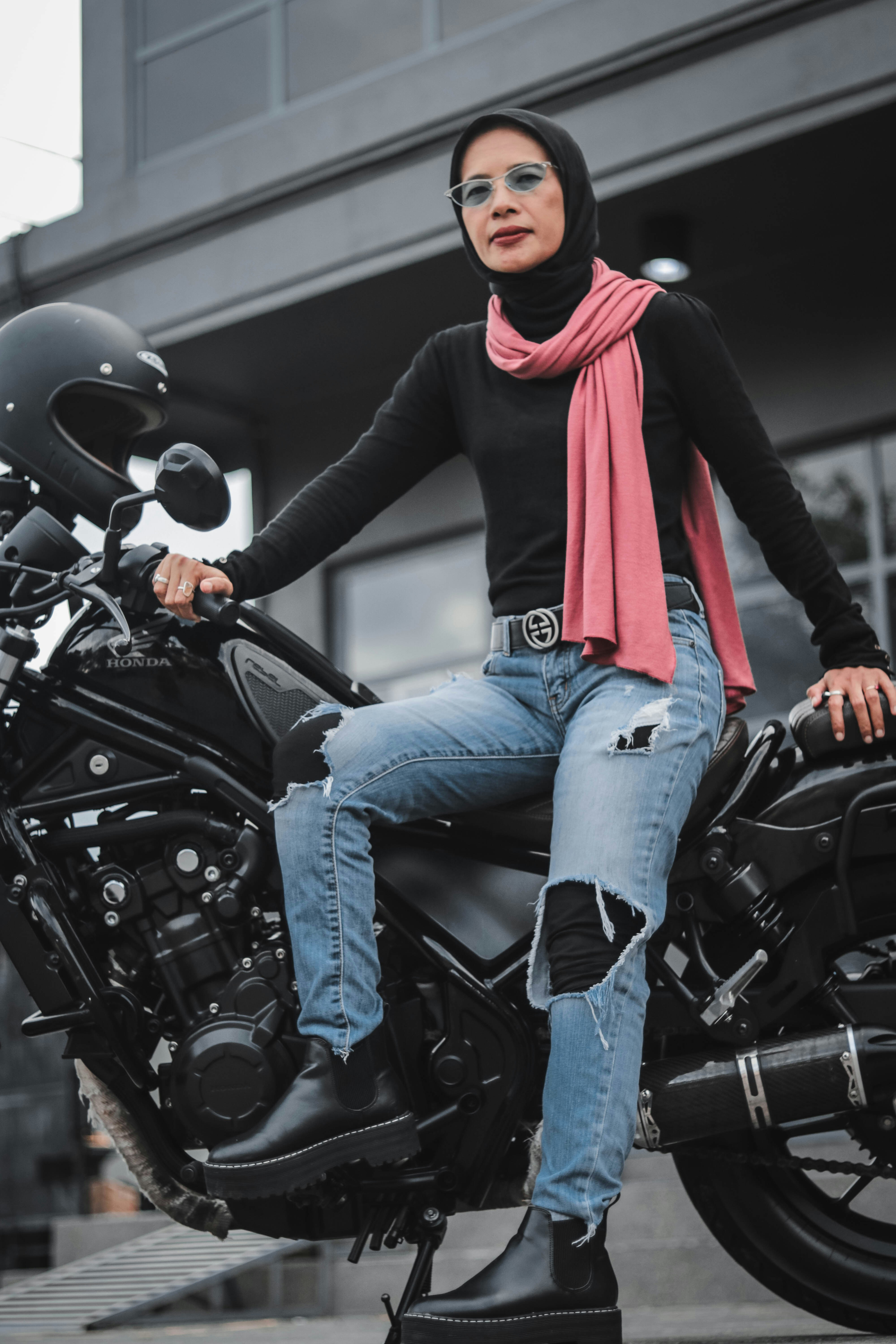 A woman sitting on top of a motorcycle