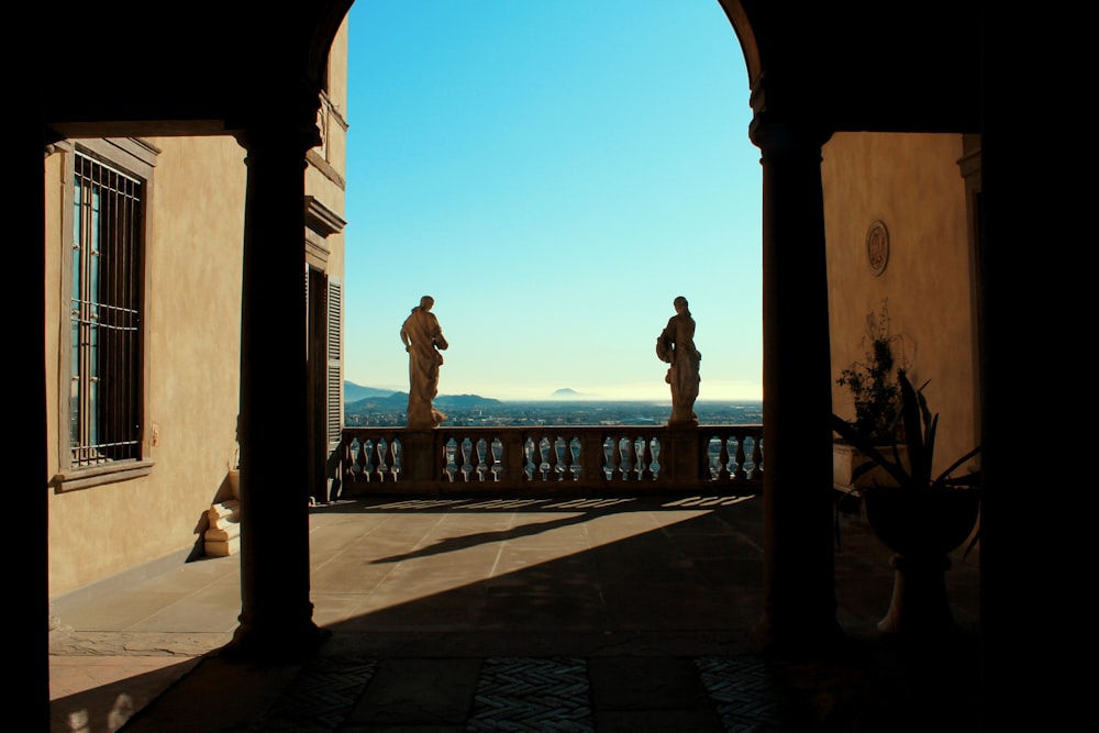 silhouette of man and woman walking on sidewalk during daytime