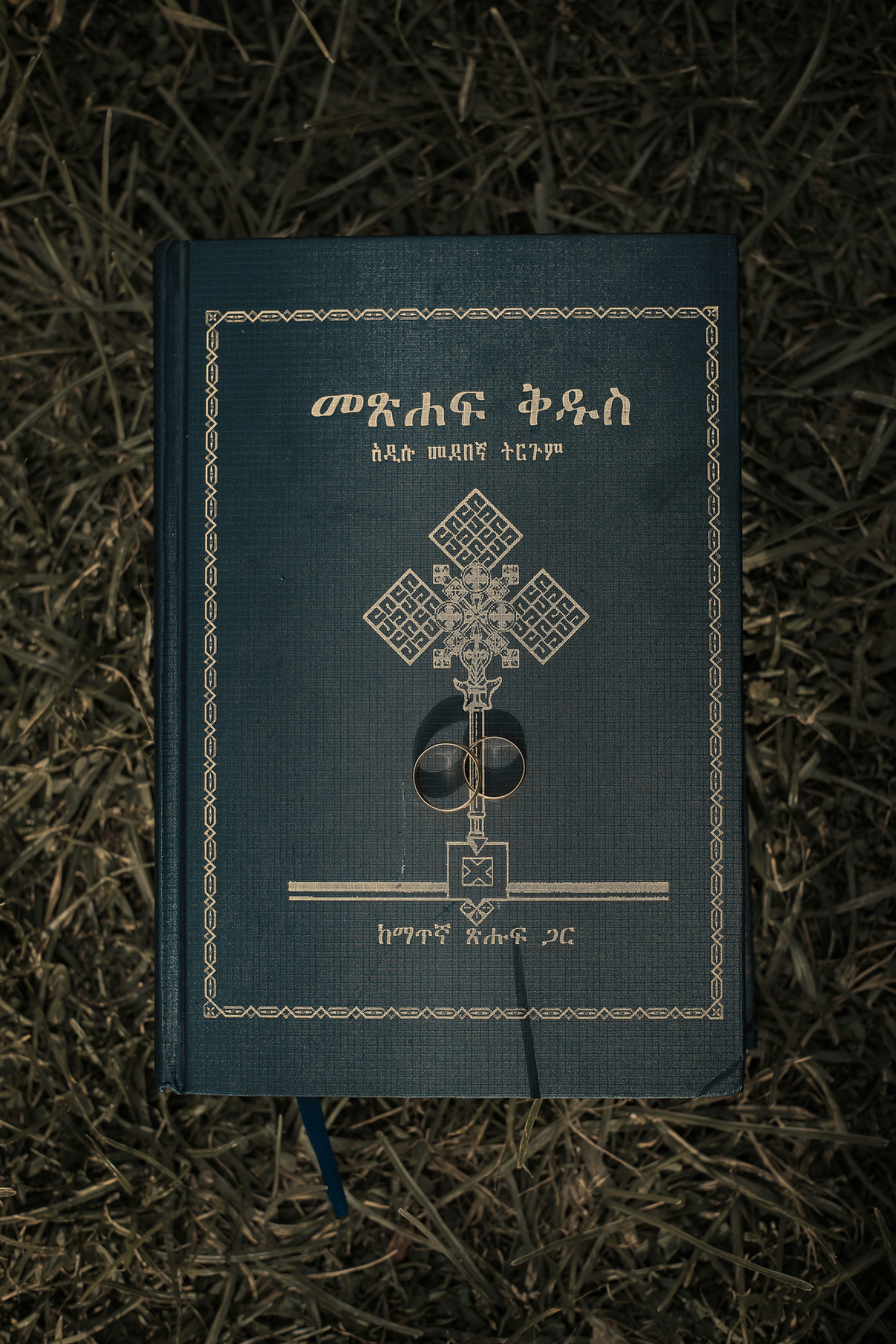 black and gold passport on brown textile