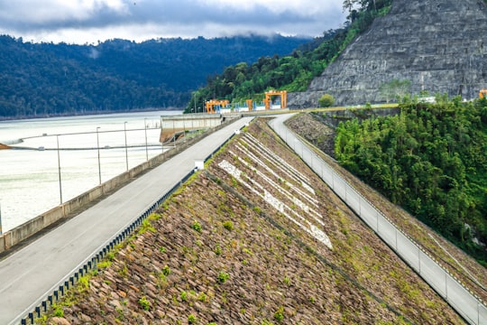 gray concrete bridge over river during daytime in Bakun Malaysia