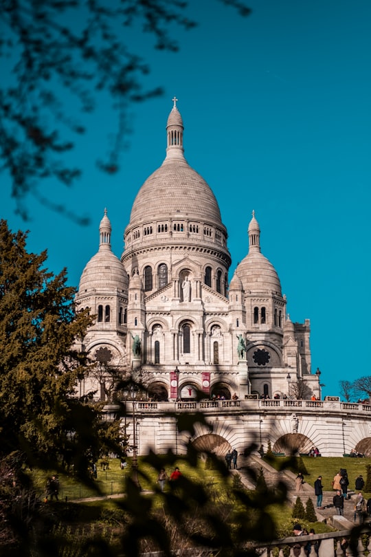 white concrete building under blue sky during daytime in Sacré-Cœur France