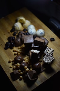 white and brown chocolate bars on brown wooden chopping board