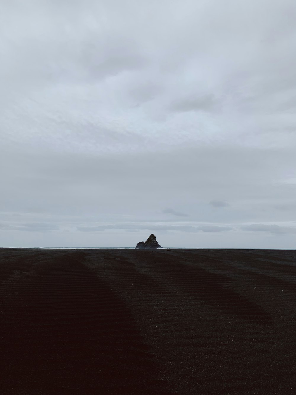 brown sand under white sky during daytime