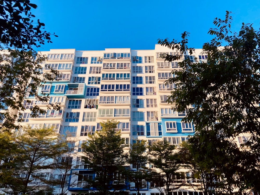 white concrete building near green trees during daytime