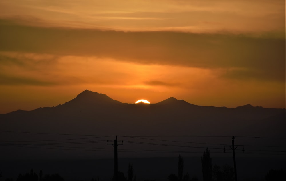 silhouette of mountain during sunset