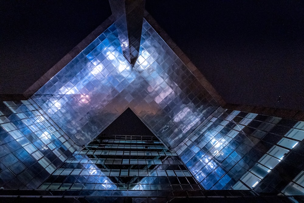 blue and black glass building during night time