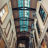 Warm and inviting view of the club’s modern fencing hall filled with natural light.