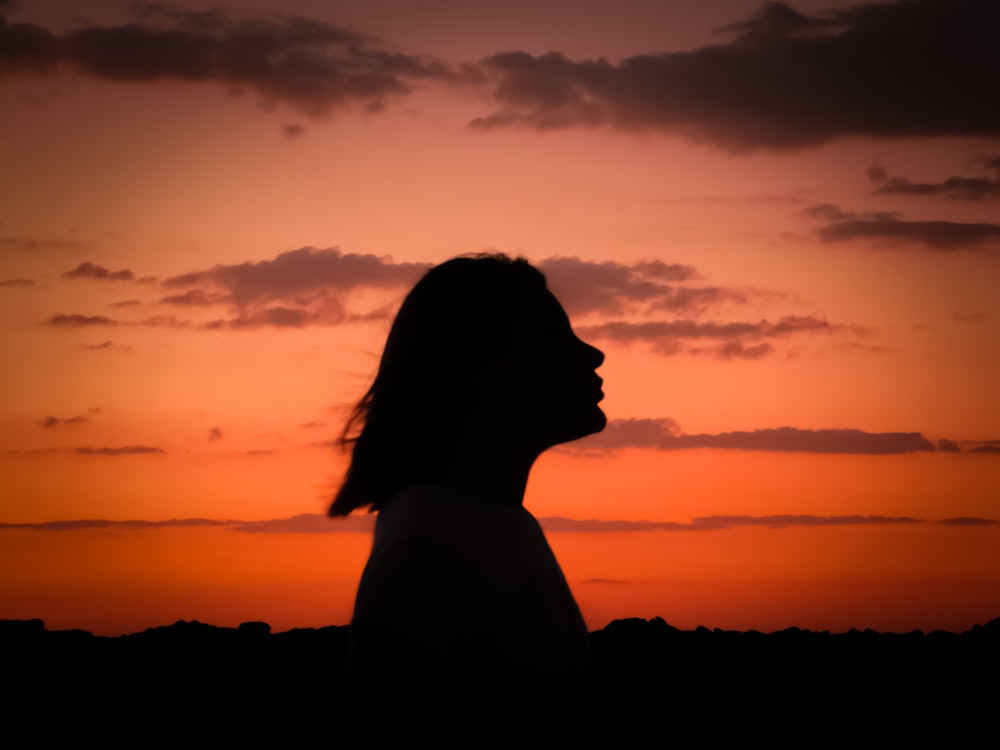 silhouette of woman during sunset