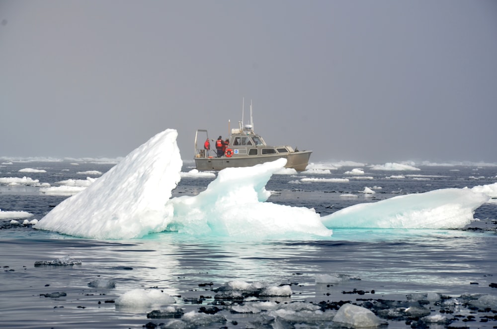 white and red boat on sea water during daytime