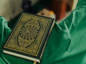 black and white book on green textile