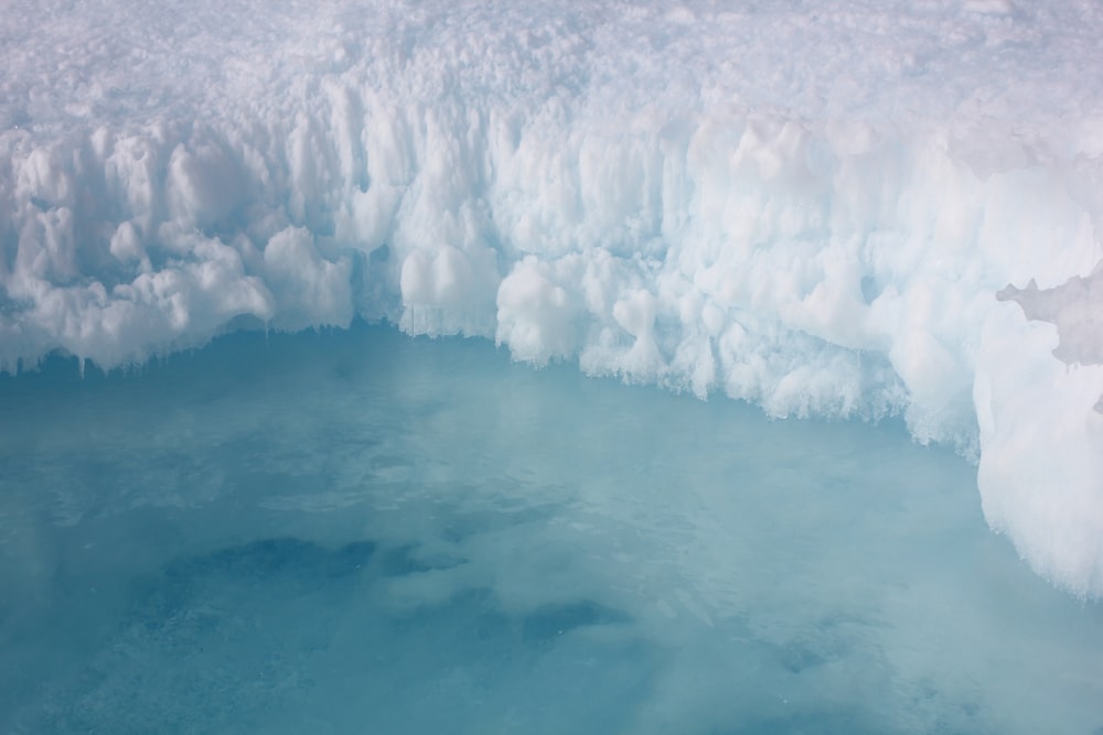 white snow on blue body of water