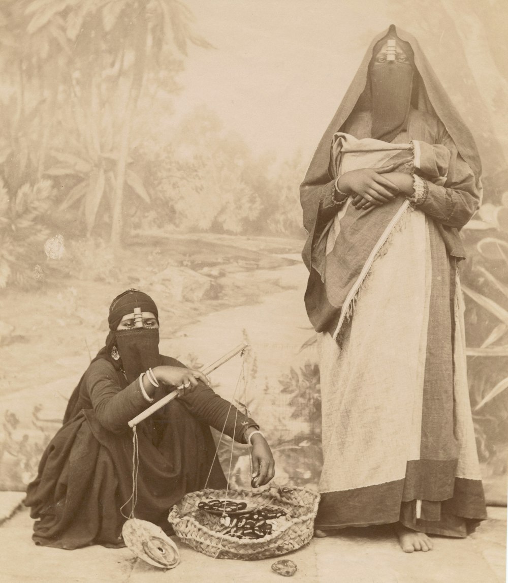 greyscale image of two women selling products outdoors