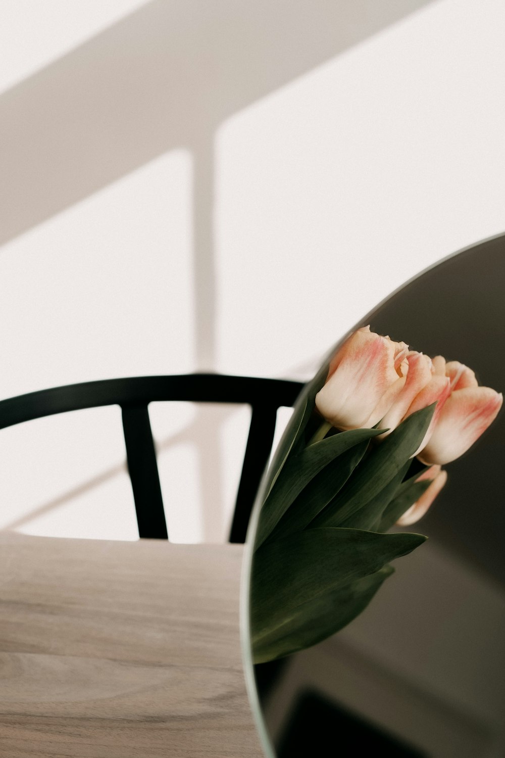 pink flower on brown wooden table