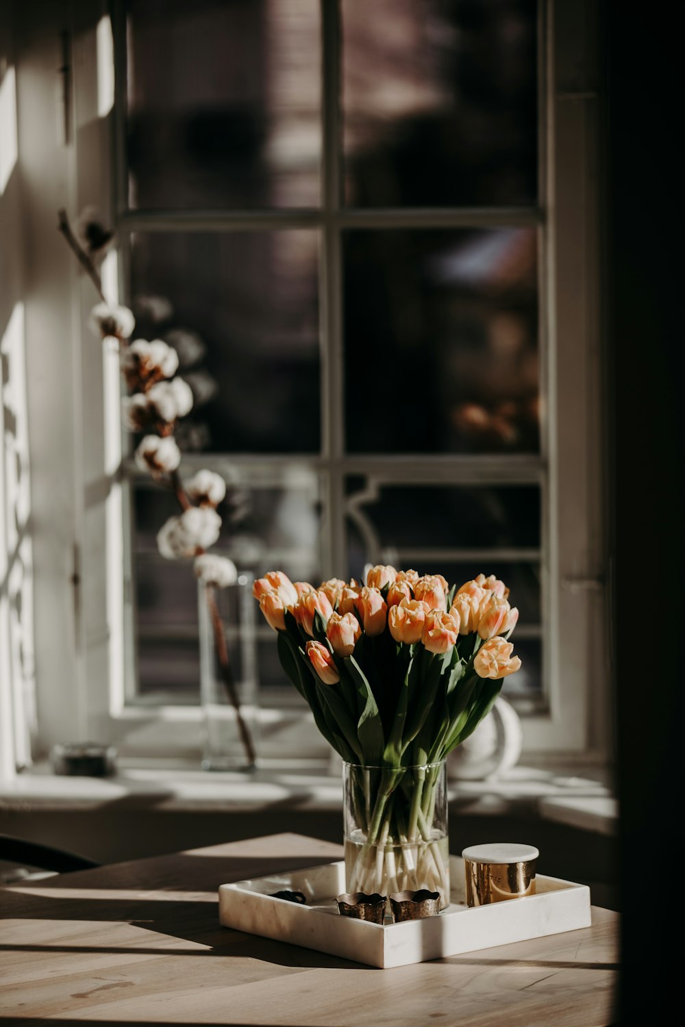 yellow and white flowers in clear glass vase