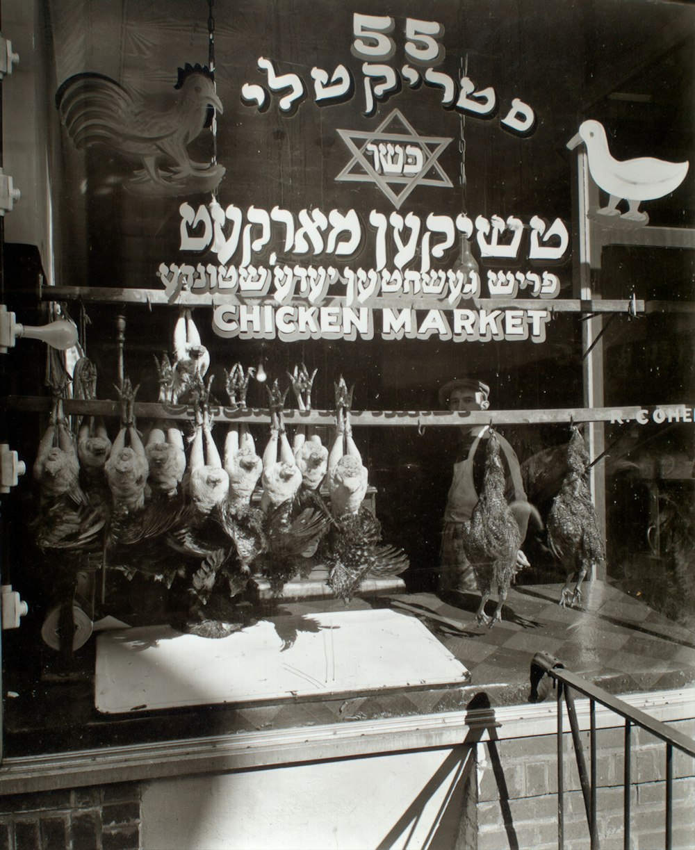 greyscale image of chicken market store window