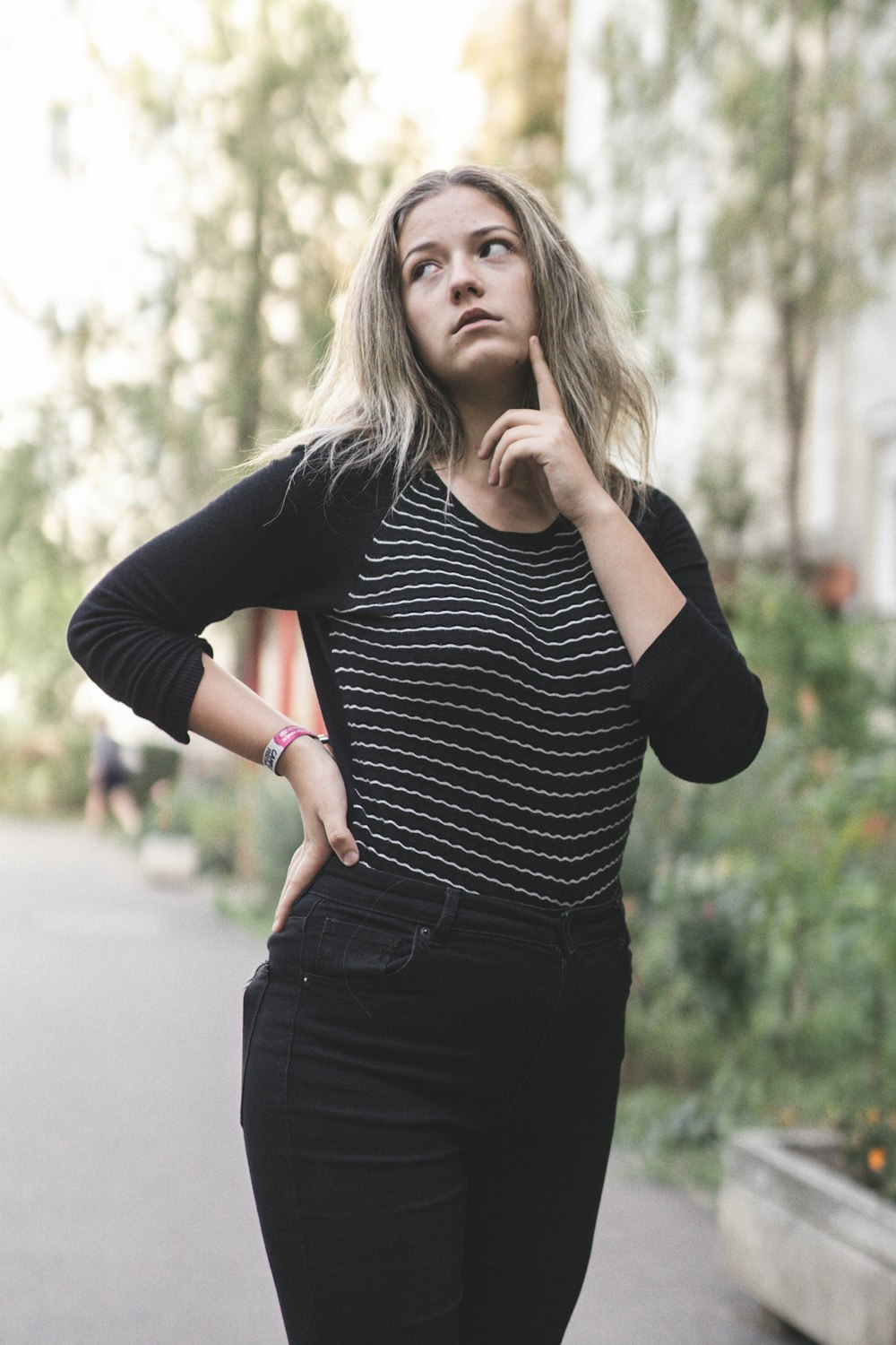 woman in black and white striped long sleeve shirt and black pants