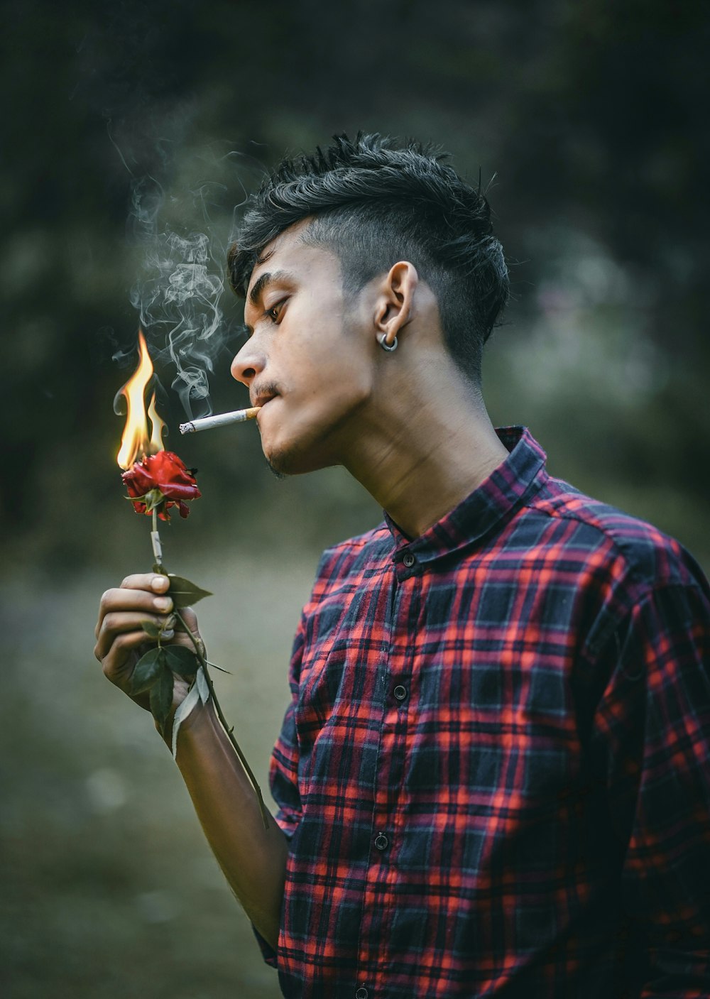 man in red and black plaid button up shirt smoking