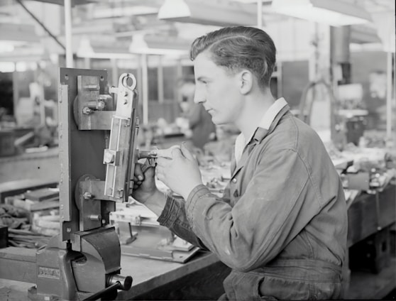 A skilled technician working on precision machinery in a modern workshop.