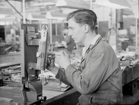 A skilled technician working on precision machinery in a workshop.