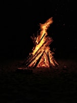 bonfire on brown sand during nighttime