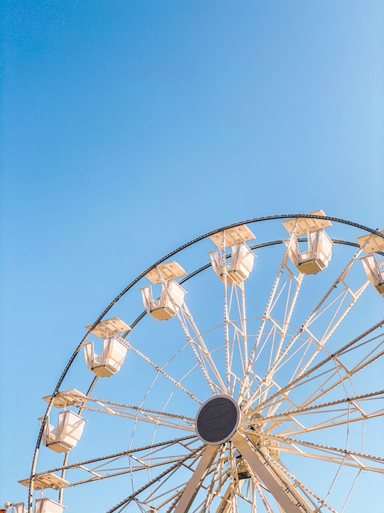 white ferris wheel under blue sky during daytime in Sibiu Romania