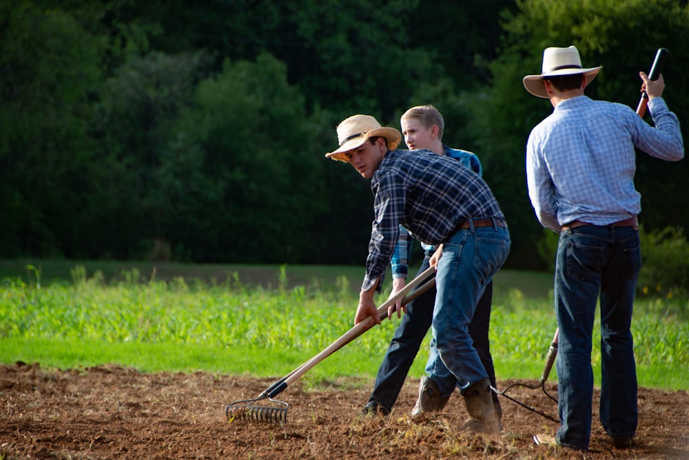 man in blue and white plaid dress shirt holding shovel