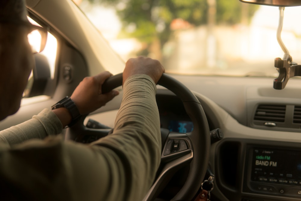 person driving car during daytime