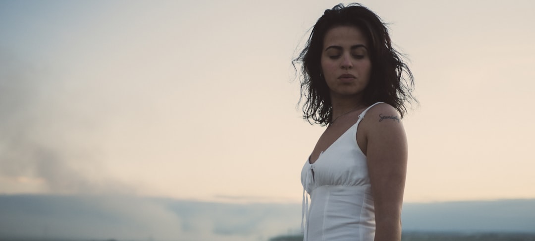 woman in white spaghetti strap top