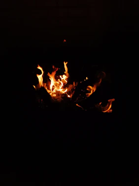A warm, intimate image of a softly glowing fire symbolizing inner transformation and awakening.