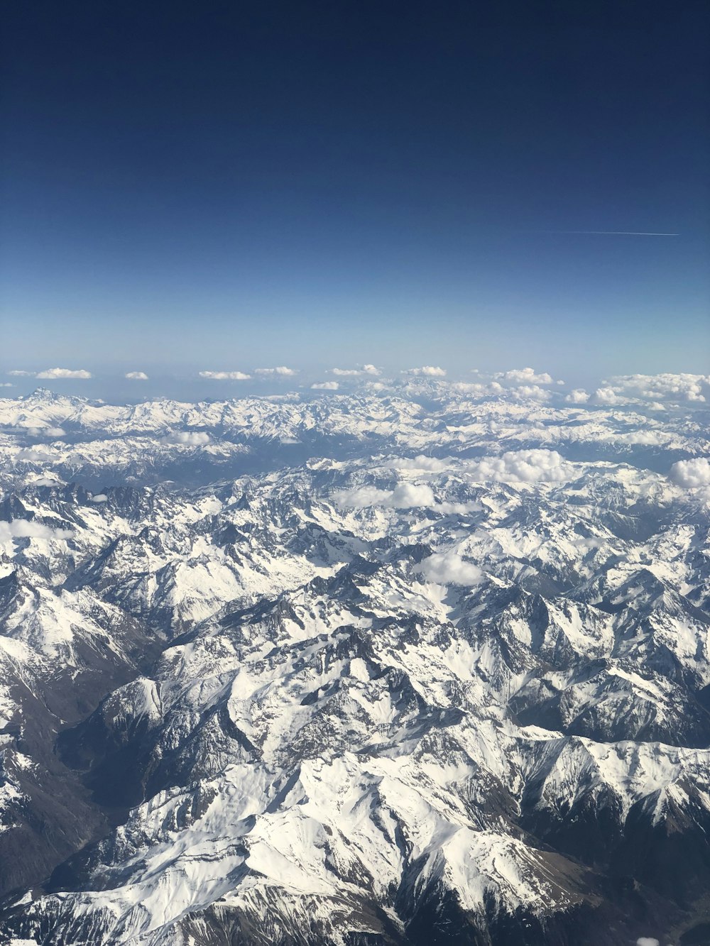 white and black mountains under blue sky during daytime