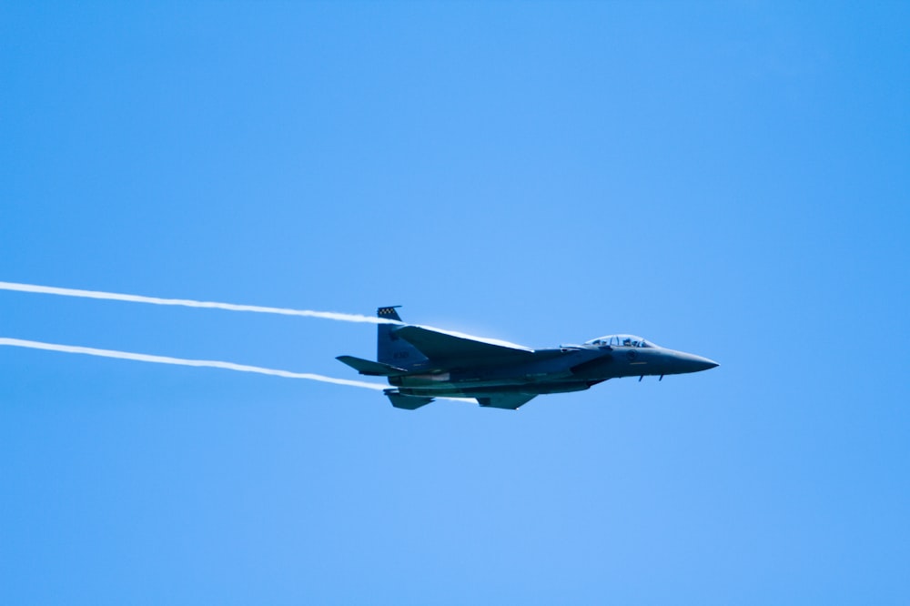 black jet plane in mid air during daytime