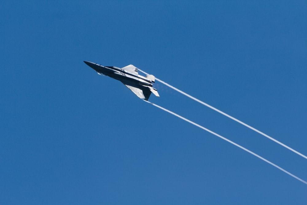 gray jet plane in mid air during daytime