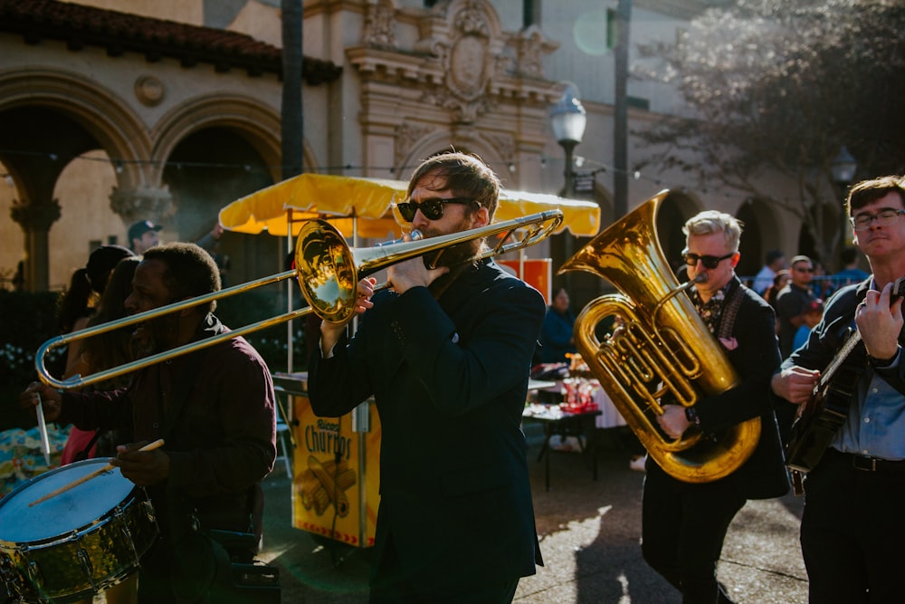 man in black long sleeve shirt playing trumpet