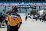 man in orange and black crew neck t-shirt wearing black helmet