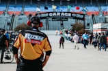 man in orange and black crew neck t-shirt wearing black helmet
