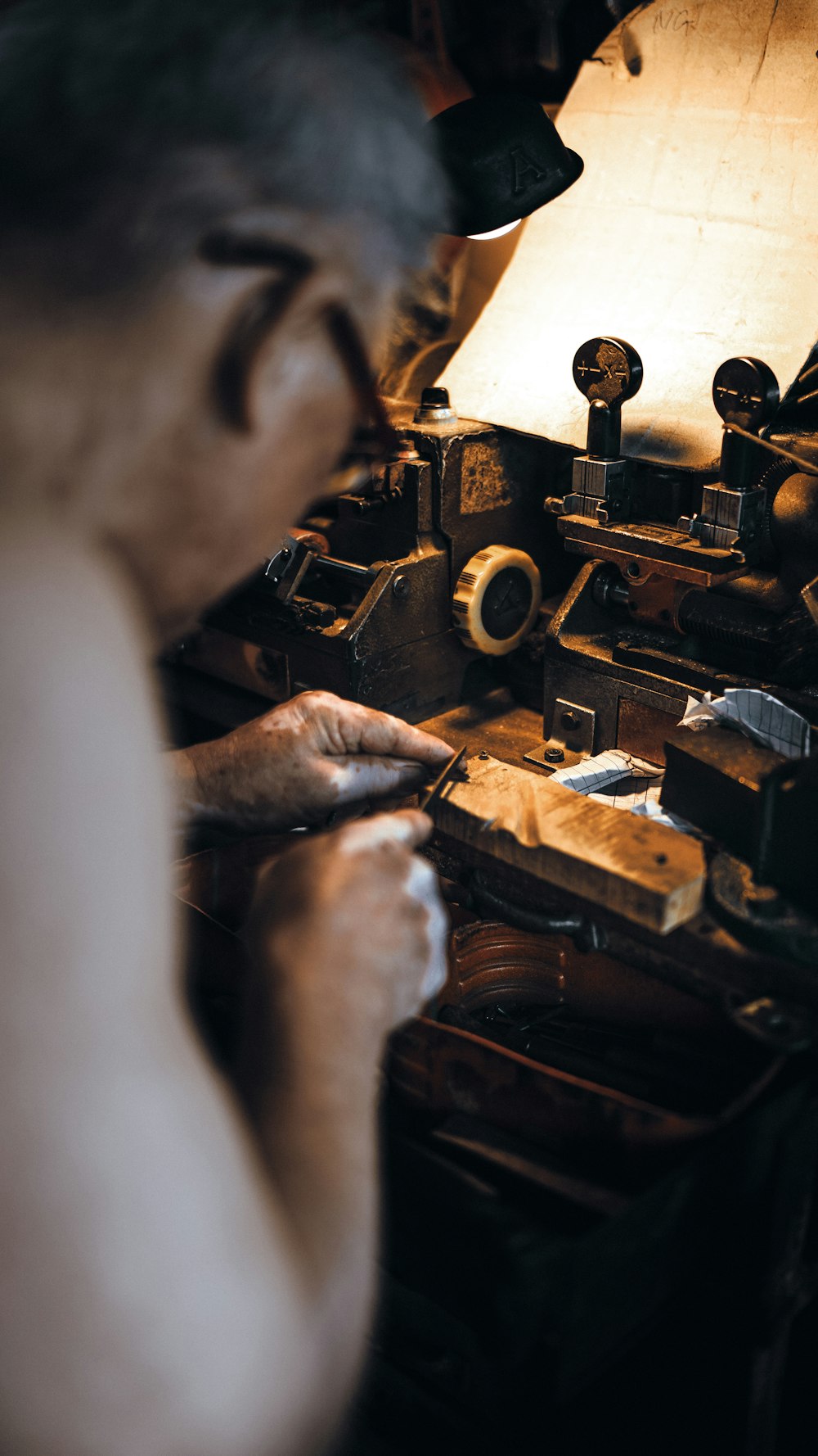 person in gray long sleeve shirt using brown sewing machine