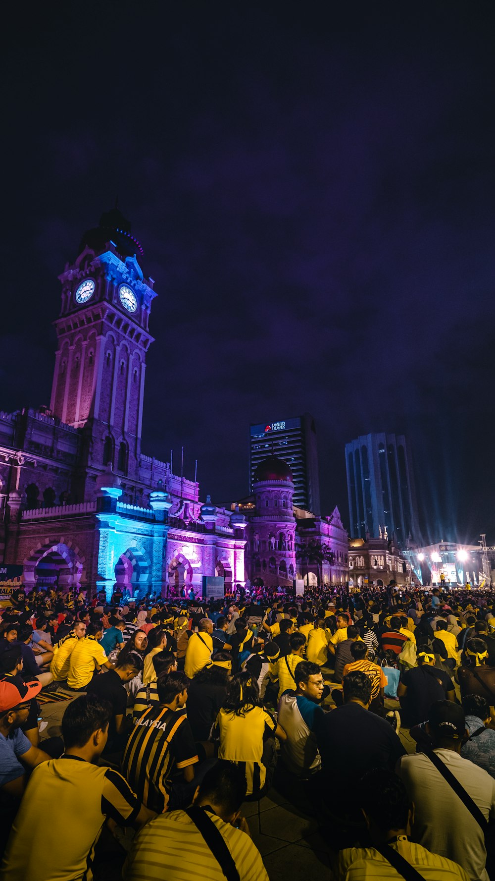 people in front of white concrete building during nighttime