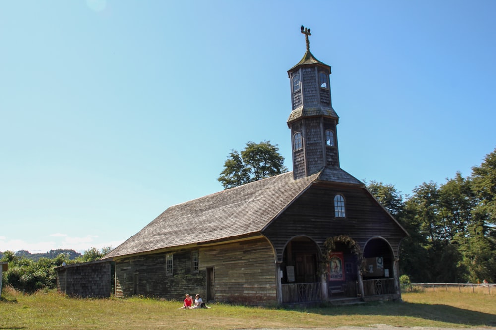 people standing in front of brown concrete church during daytime