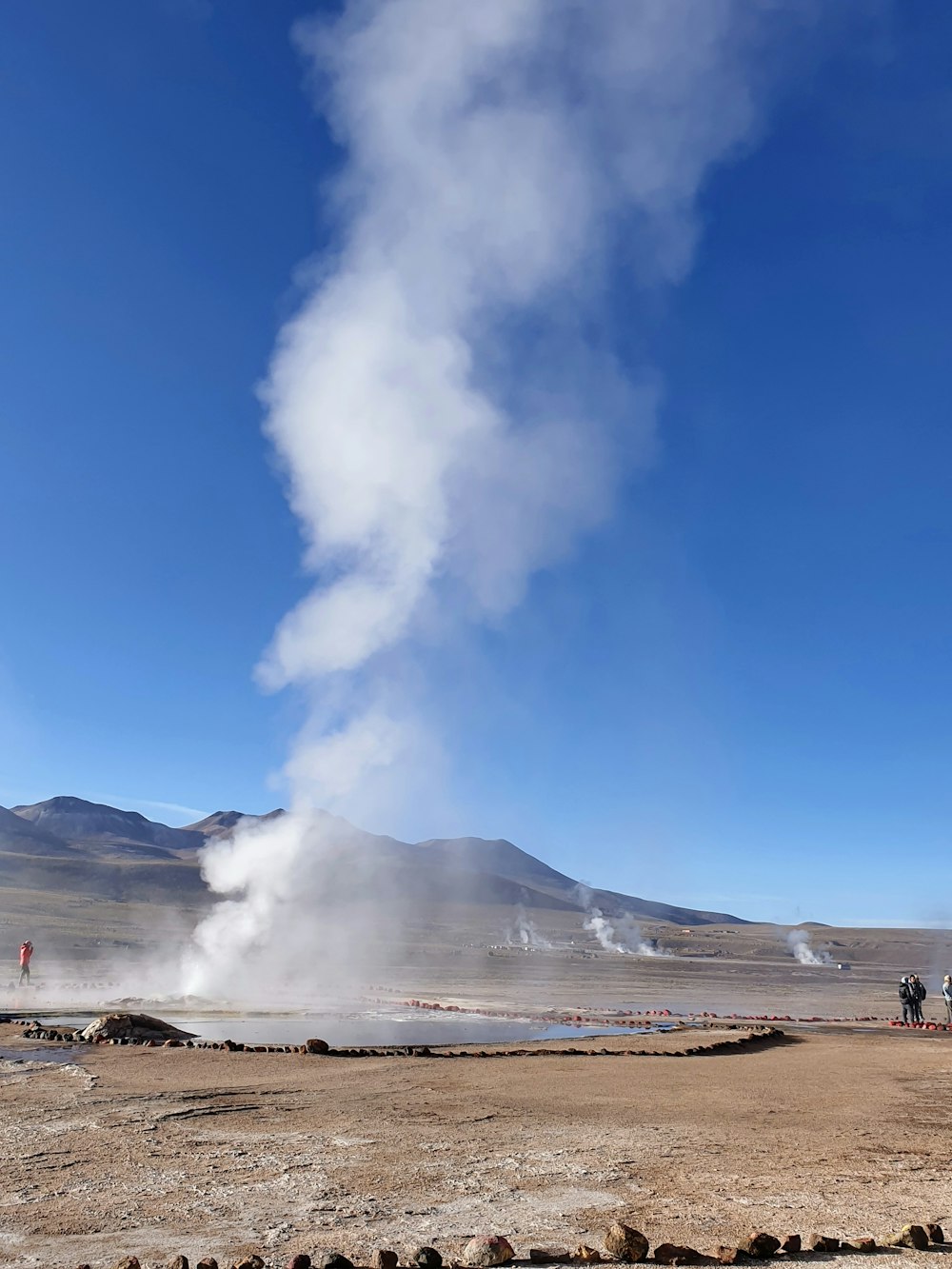 white smoke coming out from a brown field