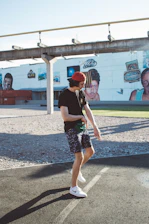 Urban streetwear outfit with oversized cargo shorts and a cap, styled on a city street background.