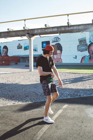 A casual street scene with a person sporting the 'Verdad Viva' t-shirt and matching cap, mid-laugh.