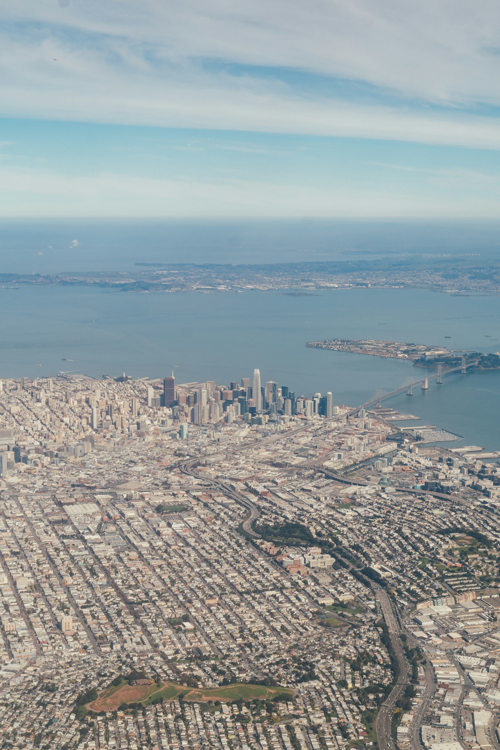 aerial view of city buildings near body of water during daytime