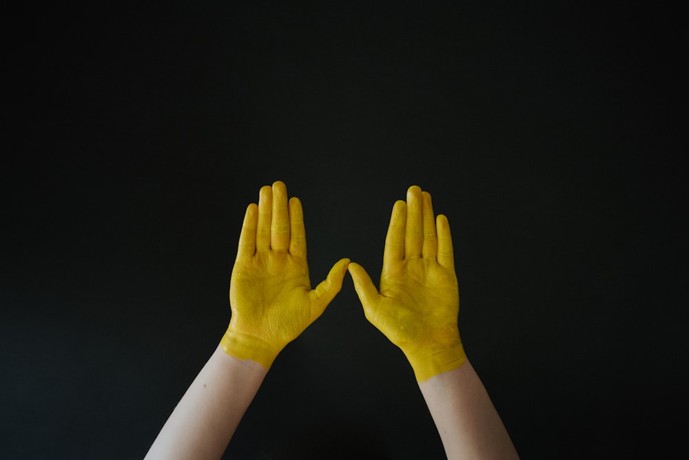 persons hand with white long sleeve shirt