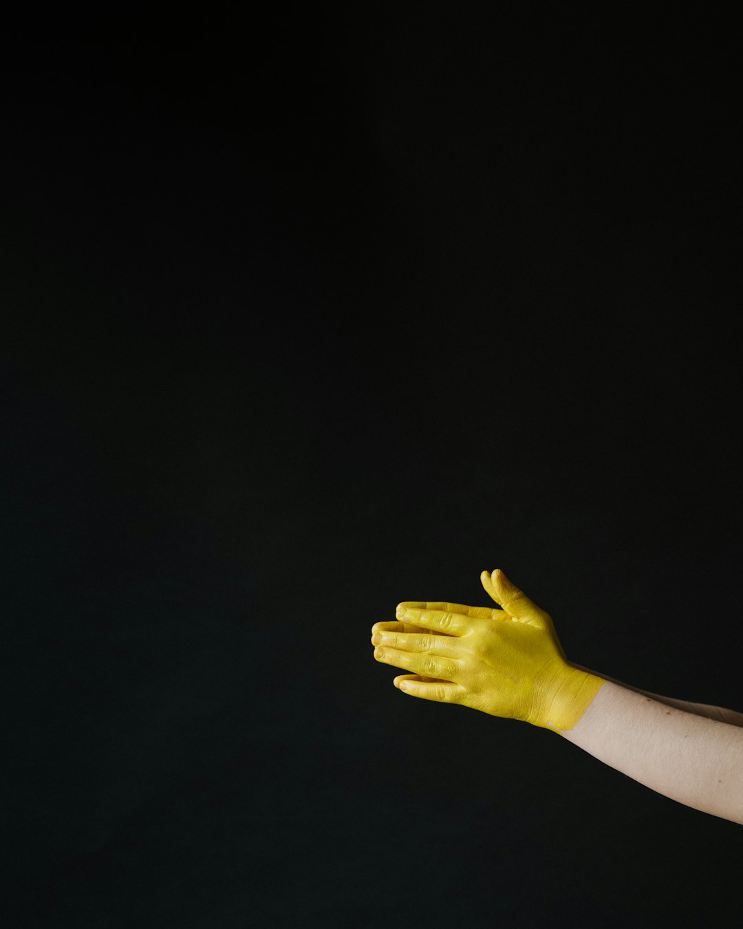 persons left hand with black background