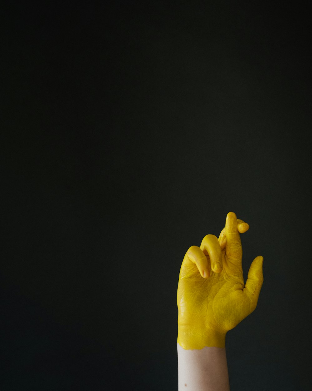 persons hand on black background