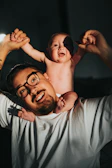 Philippe smiling with his young child, showing early steps of his fitness journey.