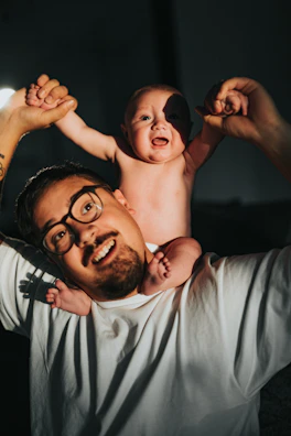 Philippe smiling with his young child, showing early steps of his fitness journey.