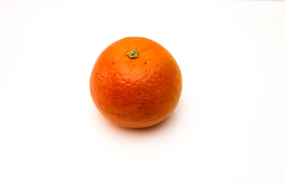 orange fruit on white surface