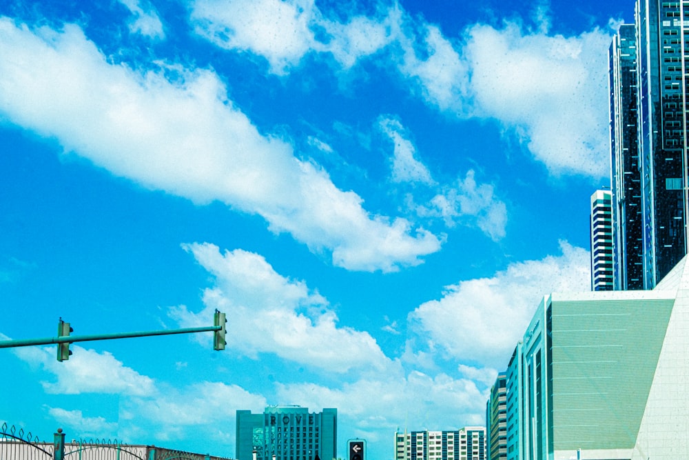 white clouds over city buildings during daytime