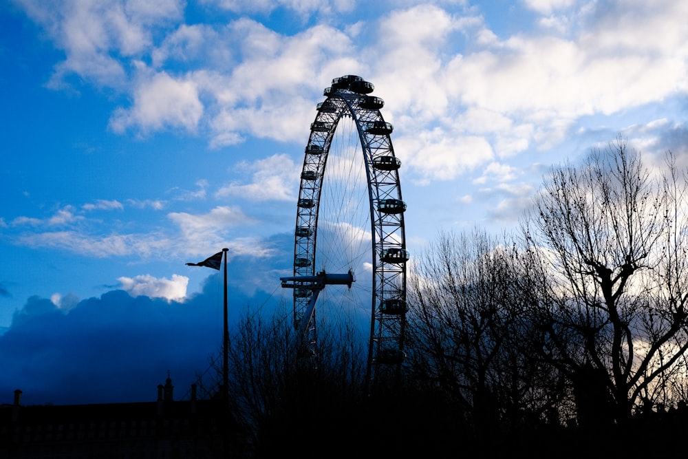 ferris wheel under cloudy sky during daytime